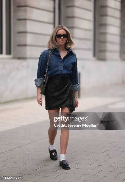 Isabelle Hartmann seen wearing Celine black sunglasses, Closed dark blue denim buttoned shirt, By Aylin König black leather short skirt, Chanel dark...