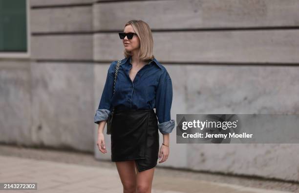 Isabelle Hartmann seen wearing Celine black sunglasses, Closed dark blue denim buttoned shirt, By Aylin König black leather short skirt and Chanel...