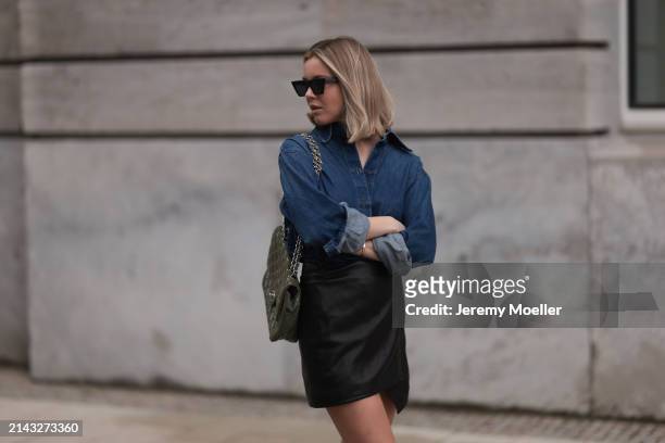 Isabelle Hartmann seen wearing Celine black sunglasses, Closed dark blue denim buttoned shirt, By Aylin König black leather short skirt and Chanel...