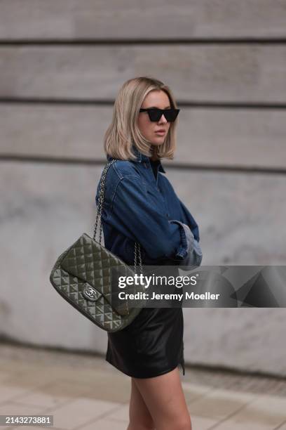 Isabelle Hartmann seen wearing Celine black sunglasses, Closed dark blue denim buttoned shirt, By Aylin König black leather short skirt and Chanel...