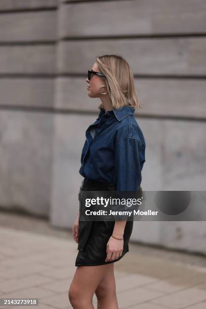 Isabelle Hartmann seen wearing Celine black sunglasses, silver earrings, Closed dark blue denim buttoned shirt, By Aylin König black leather short...