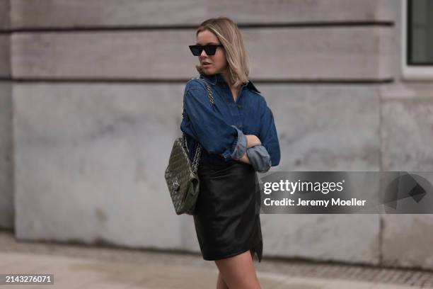 Isabelle Hartmann seen wearing Celine black sunglasses, Closed dark blue denim buttoned shirt, By Aylin König black leather short skirt and Chanel...