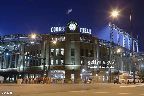 Fans leave the front entrance of Coors Field as the Arizona Diamondbacks play the Colorado Rockies into the evening in the National League game at...