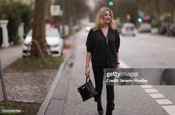 Yasmin von Schlieffen-Nannen seen wearing Chanel gold / pearl necklace, Khaite dark grey wool cardigan jacket, Lululemon black legging pants, Hermès...