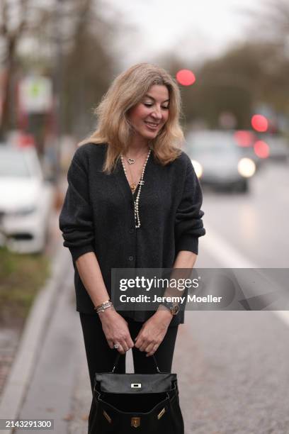 Yasmin von Schlieffen-Nannen seen wearing Chanel gold / pearl necklace, Khaite dark grey wool cardigan jacket, Lululemon black legging pants, Hermès...