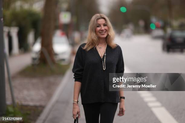 Yasmin von Schlieffen-Nannen seen wearing Chanel gold / pearl necklace, Khaite dark grey wool cardigan jacket, Lululemon black legging pants on April...