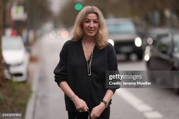 Yasmin von Schlieffen-Nannen seen wearing Chanel gold / pearl necklace, Khaite dark grey wool cardigan jacket, Lululemon black legging pants on April...