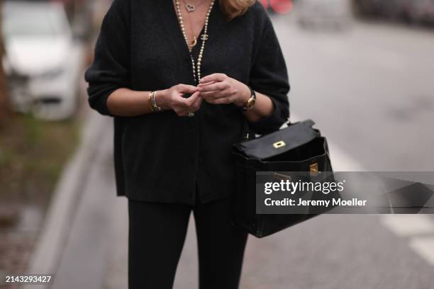 Yasmin von Schlieffen-Nannen seen wearing Chanel gold / pearl necklace, Khaite dark grey wool cardigan jacket, Lululemon black legging pants, Hermès...