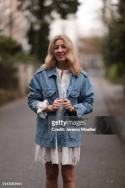 Yasmin von Schlieffen-Nannen seen wearing Isabel Marant white ruffled lace short dress, Blaze blue denim jacket and Cartier yellow gold Love bracelet...