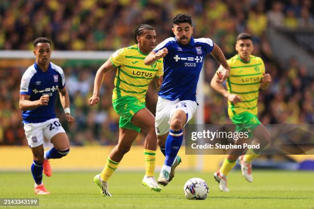 Massimo Luongo of Ipswich Town runs with the ball under pressure from Sam McCallum of Norwich City during the Sky Bet Championship match between...