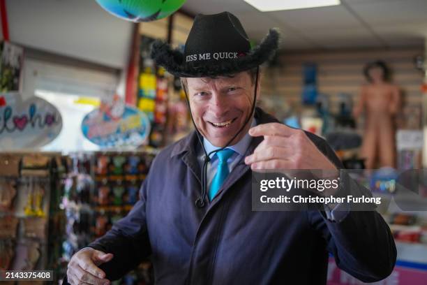 Leader of the Reform UK Party Richard Tice tries on a "Kiss Me Quick' hat during a visit to seafront businesses on April 06, 2024 in Blackpool,...