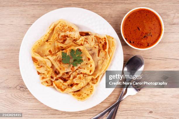 high angle view of roti canai and curry sauce - roti canai stock pictures, royalty-free photos & images
