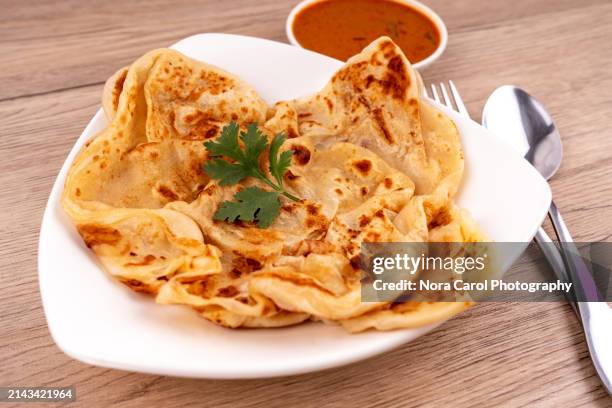 close up of roti canai and curry sauce - roti canai stock pictures, royalty-free photos & images