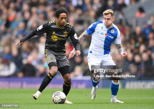 Kyle Walker-Peters of Southampton runs with the ball whilst under pressure from Sammie Szmodics of Blackburn Rovers during the Sky Bet Championship...