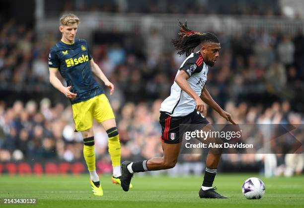 Alex Iwobi of Fulham breaks past Anthony Gordon of Newcastle United during the Premier League match between Fulham FC and Newcastle United at Craven...