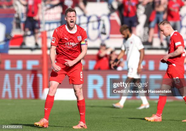 Patrick Mainka of 1.FC Heidenheim celebrates victory following the Bundesliga match between 1. FC Heidenheim 1846 and FC Bayern München at...