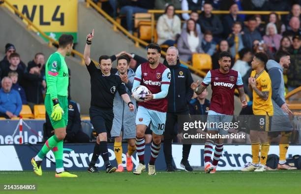 Referee Tony Harrington gestures to disallow Wolverhampton Wanderers' second goal scored by Max Kilman due to an offside on his teammate Tawanda...