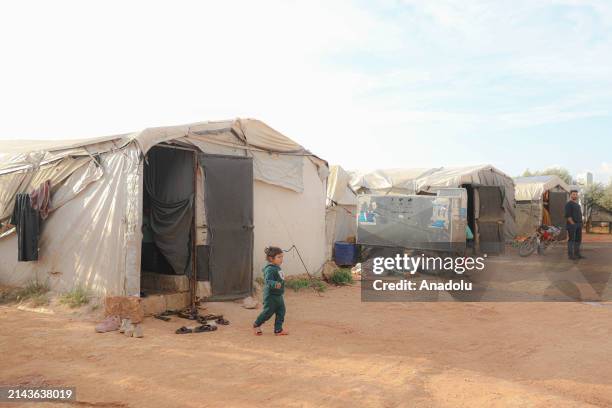 Syrian child is seen as civilians who were forcibly displaced by the attacks of Bashar al-Assad regime forces and forced to live in camps prepare to...