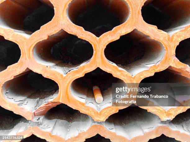 cigarette in a hole - cigar texture stock pictures, royalty-free photos & images