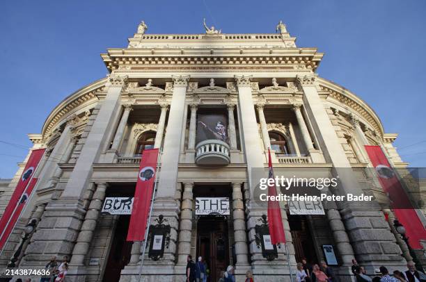 Red flags with a dog's head on them are placed in front of the Burgtheater theatre during an installation by Austrian artist Flatz called...