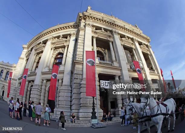 Red flags with a dog's head on them are placed in front of the Burgtheater theatre during an installation by Austrian artist Flatz called...