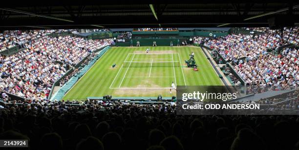 Capcity crowd watches Roger Fedrer of Switzerland and Mark Philippoussis of Australia during their Men's Final match on Centre Court at the Wimbledon...