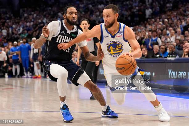 Stephen Curry of the Golden State Warriors is defended by Derrick Jones Jr. #55 of the Dallas Mavericks during the second half at American Airlines...