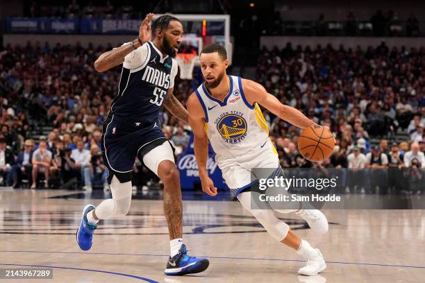 Stephen Curry of the Golden State Warriors is defended by Derrick Jones Jr. #55 of the Dallas Mavericks during the second half at American Airlines...