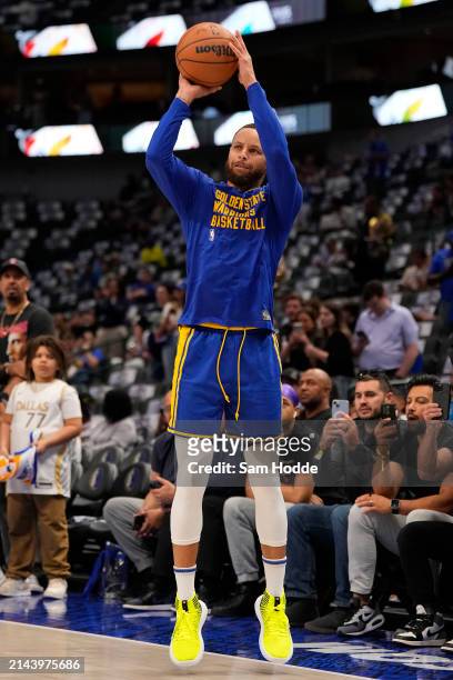 Stephen Curry of the Golden State Warriors warms up before the game against the Dallas Mavericks at American Airlines Center on April 05, 2024 in...