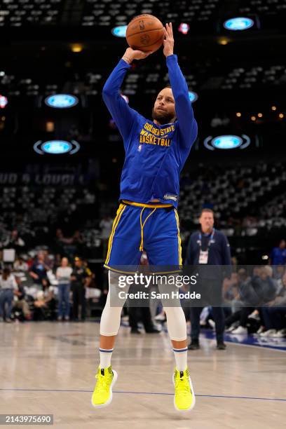 Stephen Curry of the Golden State Warriors warms up before the game against the Dallas Mavericks at American Airlines Center on April 05, 2024 in...