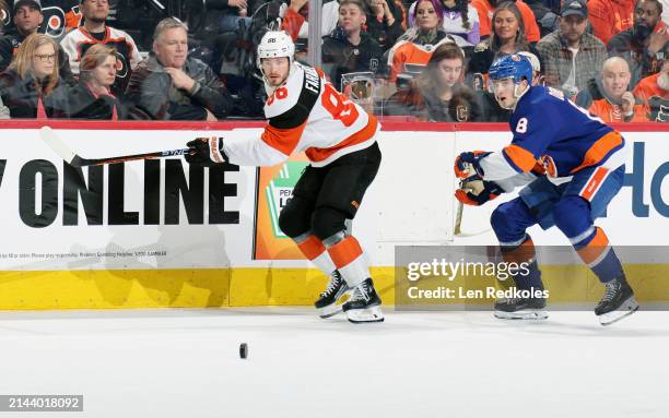 Joel Farabee of the Philadelphia Flyers skates after the puck against Noah Dobson of the New York Islanders at the Wells Fargo Center on April 1,...