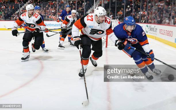 Noah Cates, Ryan Poehling and Garnet Hathaway of the Philadelphia Flyers skate against Alexander Romanov, Kyle MacLean and Noah Dobson of the New...