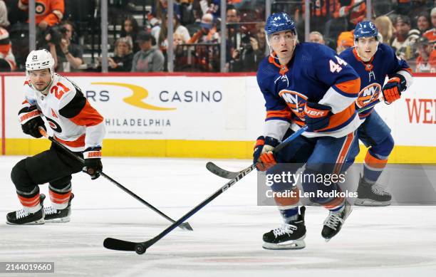 Jean-Gabriel Pageau of the New York Islanders skates the puck against Scott Laughton of the Philadelphia Flyers at the Wells Fargo Center on April 1,...