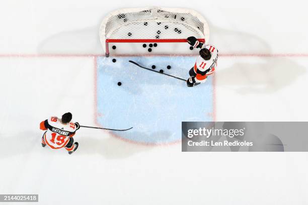 Travis Konecny and Garnet Hathaway of the Philadelphia Flyers warm-up in front of their goal prior to their game against the New York Islanders at...