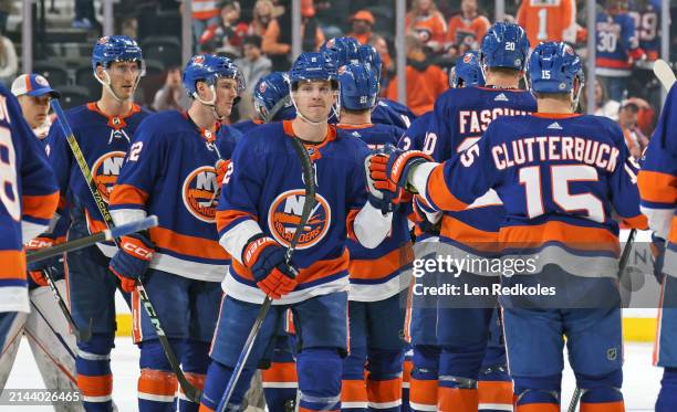 Mike Reilly of the New York Islanders celebrates with teammates after defeating the Philadelphia Flyers 4-3 in overtime at the Wells Fargo Center on...