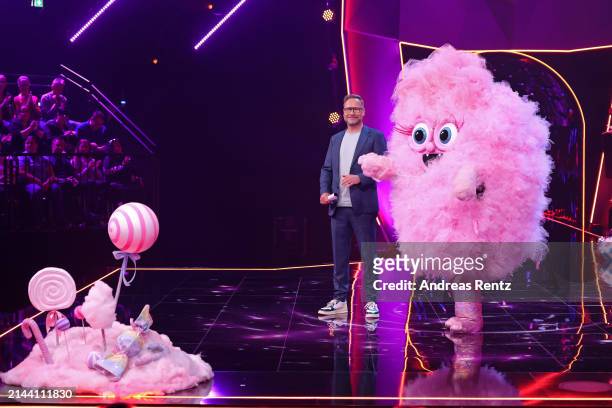 Matthias Opdenhövel and "Die Zuckerwatte" are seen on stage during the first showing of Season 10 of "The Masked Singer" at MMC Studios on April 06,...