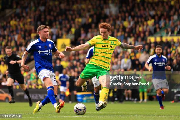 Josh Sargent of Norwich City shoots under pressure from Leif Davis of Ipswich Town during the Sky Bet Championship match between Norwich City and...
