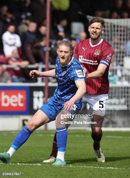 Luke Armstrong of Carlisle United and Jon Guthrie of Northampton Town in action during the Sky Bet League One match between Northampton Town and...