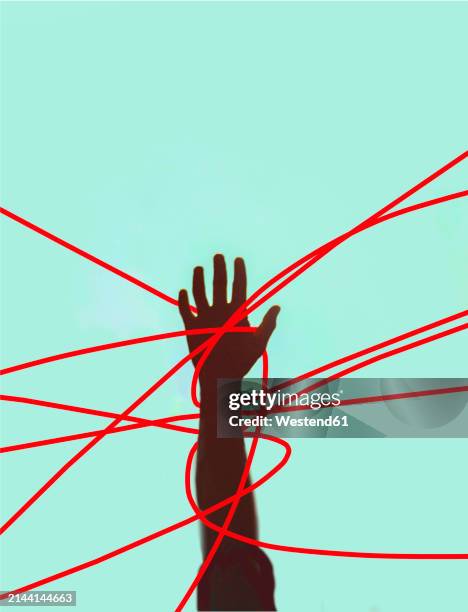 hand of unrecognizable person tangled in red strings against colored background - verheddert stock-grafiken, -clipart, -cartoons und -symbole