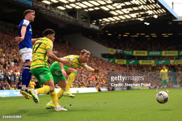 Jack Stacey and Gabriel Sara of Norwich City and Leif Davis of Ipswich Town battle for possession during the Sky Bet Championship match between...
