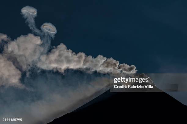 The south-east crater of Etna volcano at sunset as it emits gases and steam rings called volcanic vortex rings on April 06, 2024 in Catania, Italy....