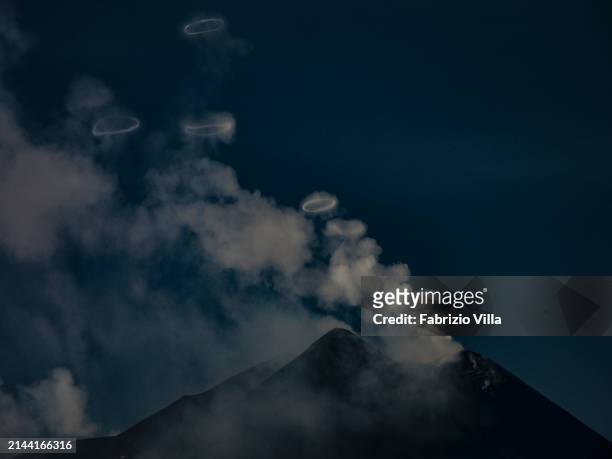 The south-east crater of Etna volcano at sunset as it emits gases and steam rings called volcanic vortex rings on April 06, 2024 in Catania, Italy....