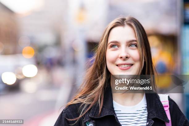smiling young woman with long brown hair - young caucasian woman brunette hair outdoors stock pictures, royalty-free photos & images