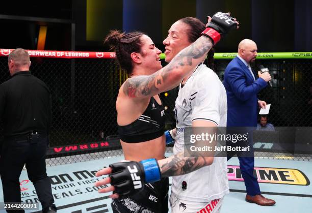 Norma Dumont of Brazil and Germaine de Randamie of The Netherlands hug after their bantamweight fight during the UFC Fight Night event at UFC APEX on...