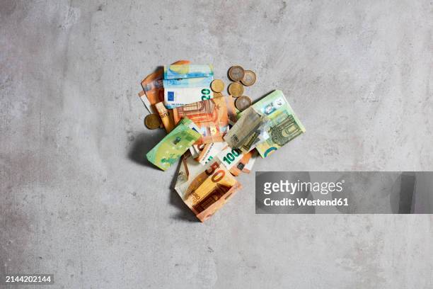 euros lying on gray surface - westend61 stock-fotos und bilder