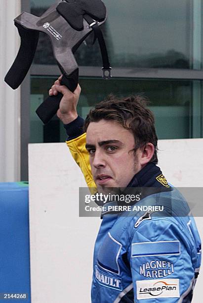 Spanish Renault driver Fernando Alonso waves to the public after he retired of the race on the Magny-Cours racetrack, 06 July 2003, during the...