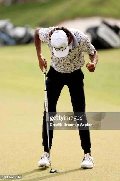 Akshay Bhatia of the United States celebrates after playing his put shot on the 18th hole during the third round of the Valero Texas Open at TPC San...