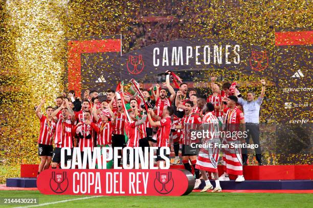 Iker Muniain and Oscar de Marcos of Athletic Club lift the Copa Del Rey trophy in celebration of victory following the Copa Del Rey Final between...