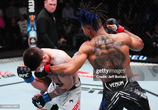 Morgan Charriere of France punches Chepe Mariscal in a featherweight fight during the UFC Fight Night event at UFC APEX on April 06, 2024 in Las...