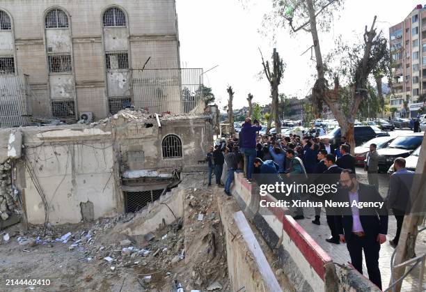Iranian Foreign Minister Hossein Amir-Abdollahian, Syrian Foreign Minister Faisal Mekdad and other officials check the site of Israeli attack on Iran...